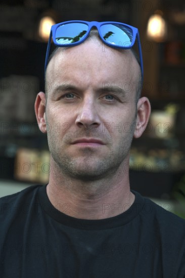 Young man with sunglasses on his head, Freiburg, Baden-Württemberg, Germany