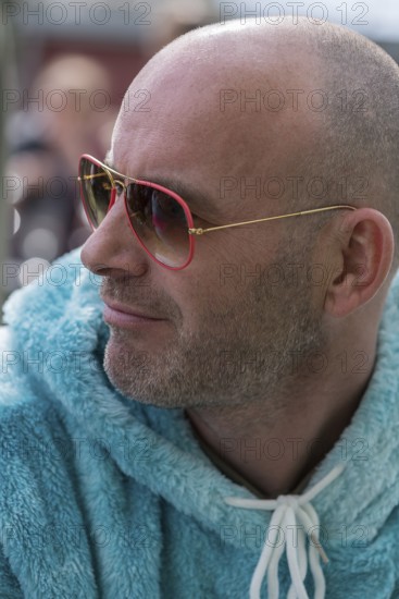 Portrait of a young man with sunglasses and fluffy jacket, Baden-Württemberg, Germany