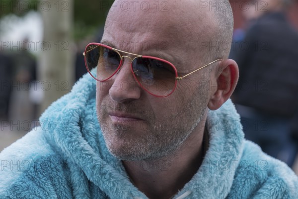 Portrait of a young man with sunglasses and fluffy jacket, Baden-Württemberg, Germany