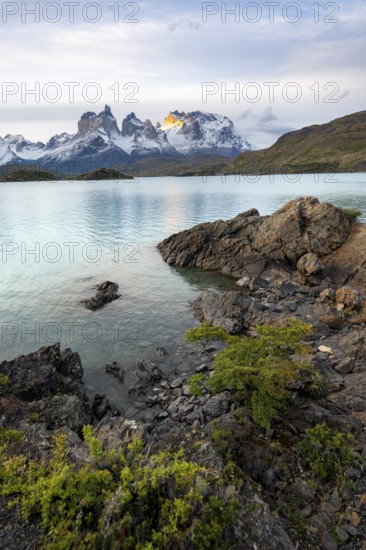 Cuernos del Paine mountain range at sunset, shore of the blue lake Lago Pehoe, Torres del Paine National Park, Chile