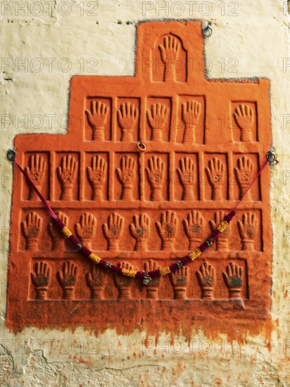 Sati stone hands mark the site of a woman's self-immolation at Mehrangarh or Meherangarh Fort, Jodhpur, Rajasthan, India