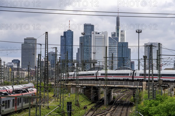 Bridge at Camberger Straße, Galluswarte, Deutsche Bahn, tracks and trains with the skyline of Frankfurt am Main, Hesse, Germany