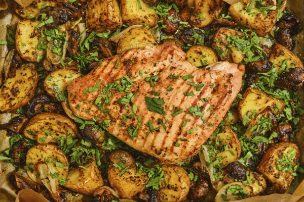 Juicy roasted turkey breast is perfectly cooked and garnished with fresh herbs, surrounded by golden seasoned potatoes and mushrooms