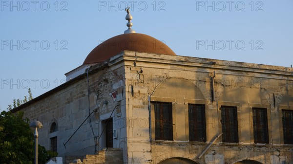 Defter-dar Mosque, Eleftherias Square, Historic building with red dome and old stone walls in the soft sunlight, Kos Town, Kos, Dodecanese, Greek Islands, Greece