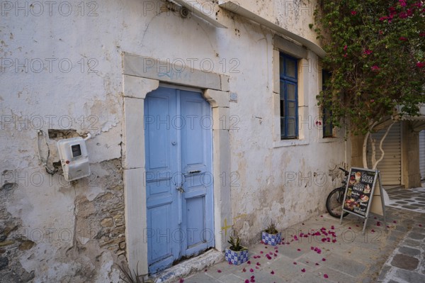 Ifestou Alley, A rustic blue-coloured door in an old wall surrounded by flowers, Kos Town, Kos, Dodecanese, Greek Islands, Greece