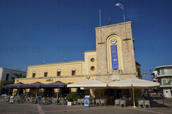 Cinema, Eleftherias Square, building with clock tower and terrace café under a clear sky, Kos Town, Kos, Dodecanese, Greek Islands, Greece