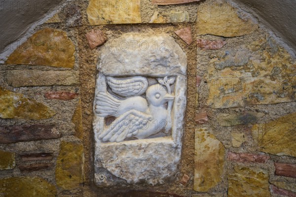Ifestou Alley, Detailed stone sculpture of a dove with an olive branch in a wall, Kos Town, Kos, Dodecanese, Greek Islands, Greece
