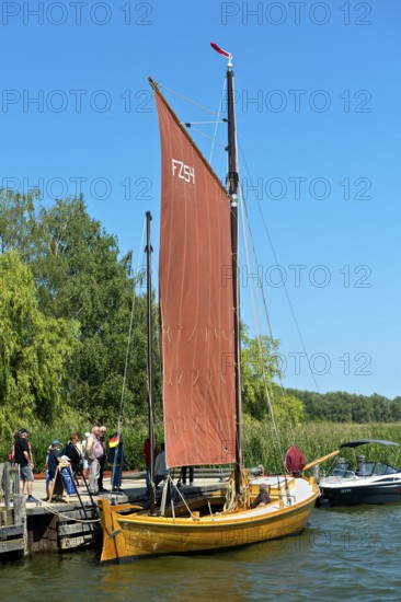 Tourists looking at a Zeesen boat at the jetty, Krummin, Usedom Island, Mecklenburg-Western Pomerania, Germany