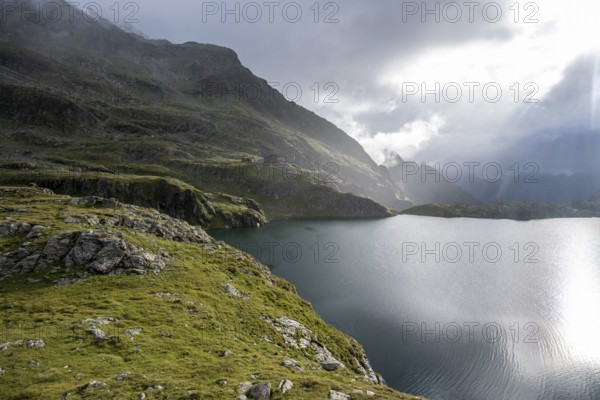 Wangenitzseehütte and mountain lake Wangenitzsee, cloudy mountain peaks in the morning, Schober group, Hohe Tauern National Park, Carinthia, Austria