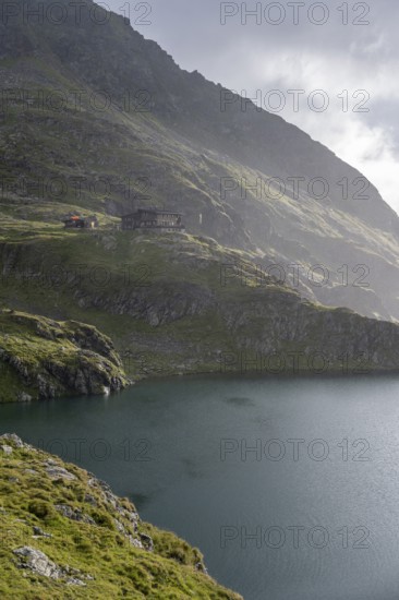 Wangenitzseehütte and mountain lake Wangenitzsee, cloudy mountain peaks in the morning, Schober group, Hohe Tauern National Park, Carinthia, Austria