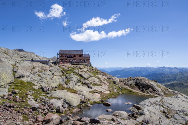 Teplitzerhütte mountain hut and small mountain lake, Stubai Alps, South Tyrol, Italy