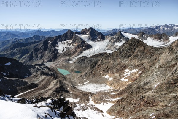 View of mountain basin with blue glacier lakes, behind summit Becher with Becherhaus, glacier Übeltalferner and summit Königshofspitz, descent from summit Wilder Freiger to Roter Grat, Stubai Alps, South Tyrol, Italy