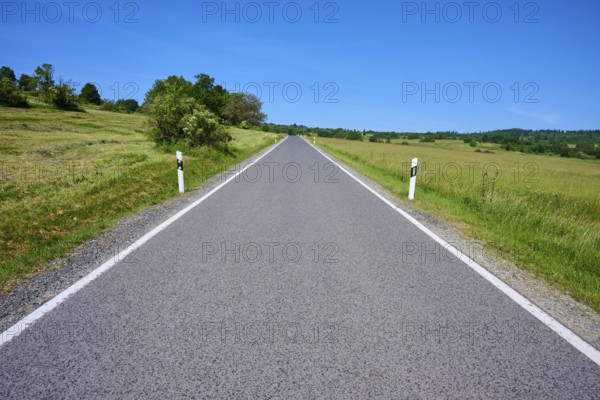 Straight country road runs through open landscape with blue sky, summer, Franzosenweg, Lange Rhön, Oberelsbach, Rhön, Bavaria, Germany