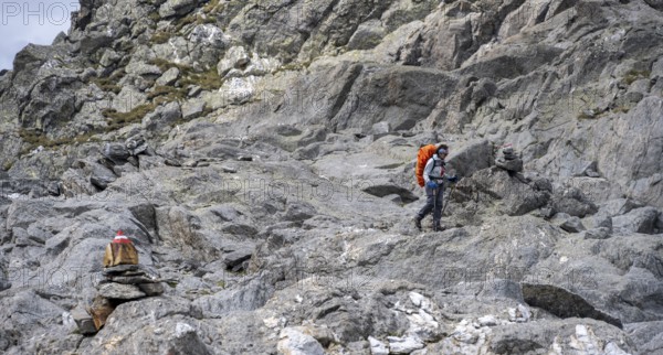 Mountaineer between rocks, Wiener Höhenweg, Schober group, Hohe Tauern National Park, Carinthia, Austria