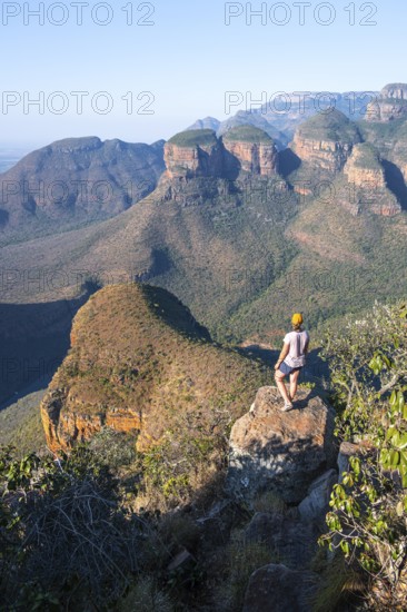 Hiker at Blyde River Canyon with Three Rondawels peak, view of canyon with Blyde River and Table Mountains, canyon landscape, Panorama Route, Mpumalanga, South Africa