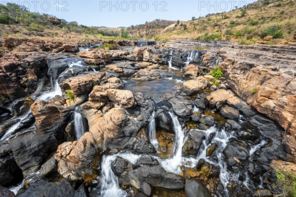 Waterfall on orange-coloured rock cliffs, long exposure, Blyde River, Bourke's Luck Potholes, Panorama Route, Mpumalanga, South Africa