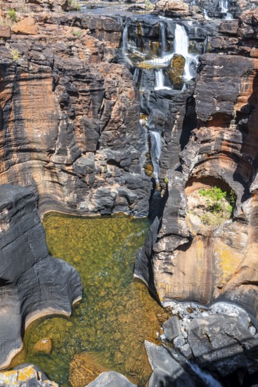 Waterfall on orange-coloured rock cliffs, long exposure, Blyde River, Bourke's Luck Potholes, Panorama Route, Mpumalanga, South Africa