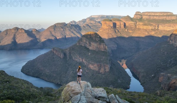 Hiker enjoying panorama, Blyde River Canyon with summit Three Rondawels, view of canyon with river Blyde River and table mountains, canyon landscape, Panorama Route, Mpumalanga, South Africa
