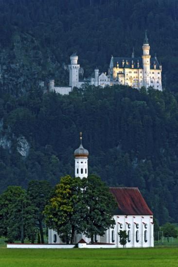 Pilgrimage church of St Coloman, Baroque, Neuschwanstein Castle by King Ludwig II, fairytale castle in the Neo-Romanesque style, UNESCO World Heritage Site, illumination at the blue hour, Schwangau, Füssen, Allgäu, Swabia, Bavaria, Germany