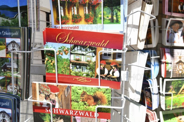 Forbach, Germany - July 12th 2025: Postcards of the German Black Forest displayed on a card stand for sale. Tourist souvenirs from the Schwarzwald region