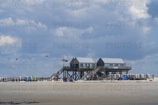 New pile dwellings on the beach with lifeguards and toilets, cloudy, Sankt Peter Ording, Eiderstedt, North Frisia, North Sea, Schleswig-Holstein, Germany
