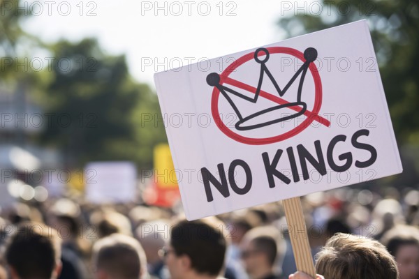 Protest sign with text No kings and crossed-out crown. Demonstration in progress. Generative AI, AI generated