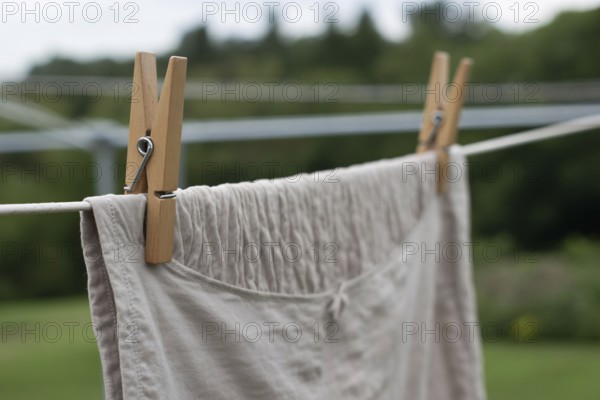 Laundry hanging with wooden cloth pegs. Generative ai, AI generated