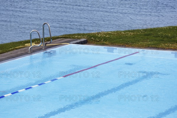 View from above of swimming pool by the sea, thermal bath, heated outdoor pool in Hofsos at the fjord Skagafjördur, Lake Greenland, Hofsos, Tröllaskagi peninsula, Nordurland vestra, North Iceland, Iceland