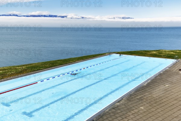View from above of infinity pool by the sea, thermal bath, heated outdoor pool in Hofsos by Skagafjördur fjord, Lake Greenland, Hofsos, Tröllaskagi peninsula, Nordurland vestra, North Iceland, Iceland