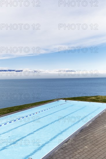 View from above of infinity pool by the sea, thermal bath, heated outdoor pool in Hofsos by Skagafjördur fjord, Lake Greenland, Hofsos, Tröllaskagi peninsula, Nordurland vestra, North Iceland, Iceland