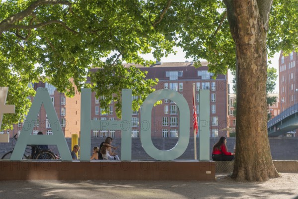 Schlachte, historical promenade along the Weser, sailor's greeting, lettering Ahoy, trees, backlight, view of the Terrhof, old town, people sitting in the shade, Hanseatic city of Bremen, Germany