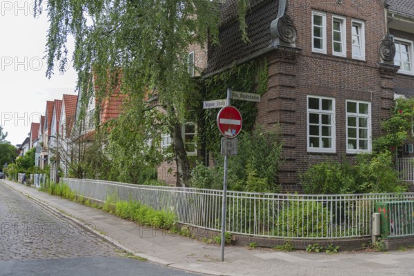 Living in the district WQeidedamm, Torgauer Stasse, corner Am Weidedamm, brick architecture, gabled houses, semi-detached houses, cobblestone pavement, quiet residential area, front garden with trees and plants, Hanseatic City of Bremen, Germany