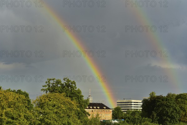 Rainbow over the city of Augsburg, in the centre of the picture the hotel tower, Augsburg, Bavaria, Germany