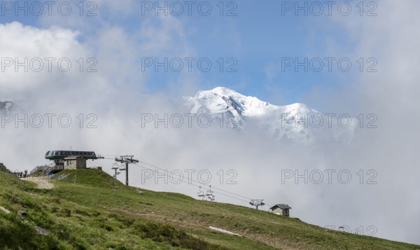 Ski lift in the Domaine de Balme ski area at Col de Balme, in summer, behind the summit of Mont Blanc, Chamonix, Haute-Savoie, France