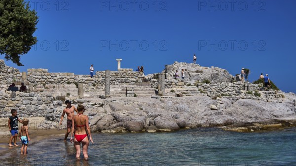 People and children exploring ancient ruins on the beach in sunny weather, Agios Stefanos Beach, Agios Stefanos Basilica, Basilica, Kastri Island, Kos, Dodecanese, Greek Islands, Greece