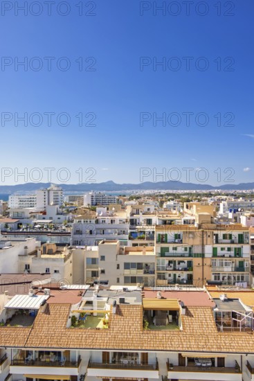 Skyline view above the house roofs in a city with tower blocks in a residental area, Can Pastilla, Mallorca, Spain