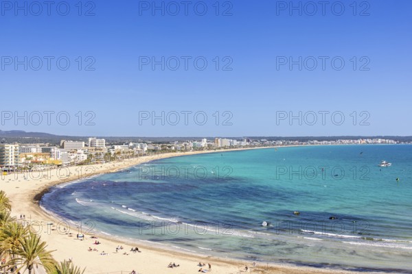 Aerial view at a tourist resort area with sunbathing people on the sand beach by the blue mediterranean Sea, Can Pastilla, Mallorca, Spain
