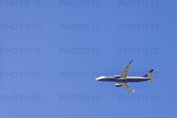 Ryanair passenger plane flying in a blue sky
