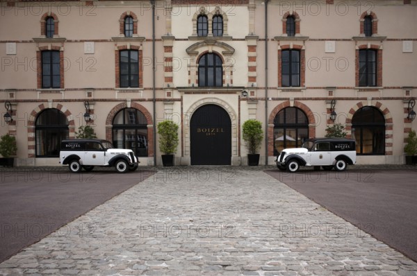 Black and white Renault Juvaquatre Editorial vintage cars in front of headquarters, head office, Atelier 1834 Champagne Boizel, Avenue de Champagne, Épernay, Marne, France