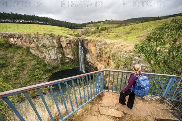 Young woman on a viewing platform, waterfall flowing into a canyon, Berlin Falls, long exposure, near Graskop, Mpumalanga, South Africa