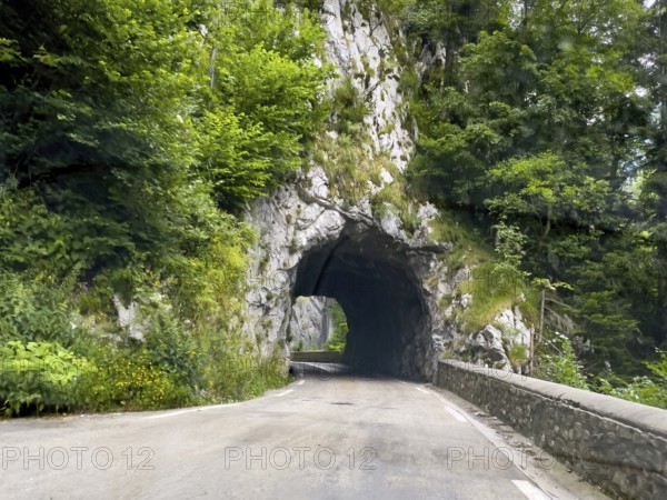 Narrow single-lane tunnel through rocks on departmental road D512 Route du Col de Porte mountain road in Western Alps north of Grenoble, Sarcenas, Arrondissement Grenoble, Département Isère, Region Auvergne-Rhône-Alpes, France