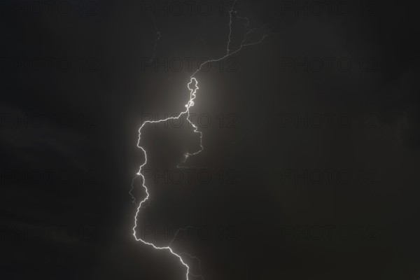 Dark clouds gather as lightning strikes light up the night. The intense storm brings thunder and rain. Bas rhin, Alsace, grand est, France