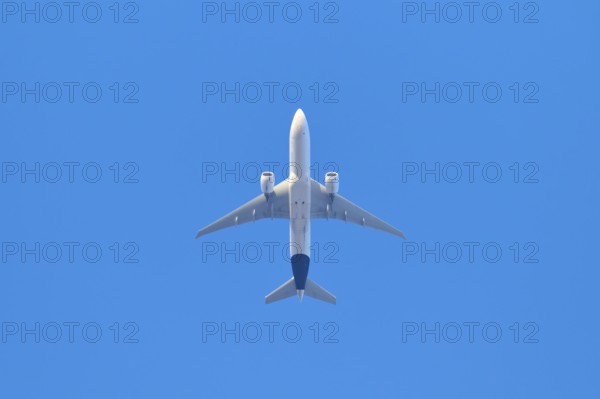 Aeroplane flies high in the clear blue sky and symbolises wanderlust, Germany