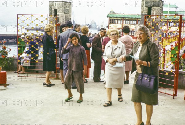 People at entrance gates to Tai Pak floating restaurant, Castle Peak, New Territories, Hong Kong, Asia, 1964