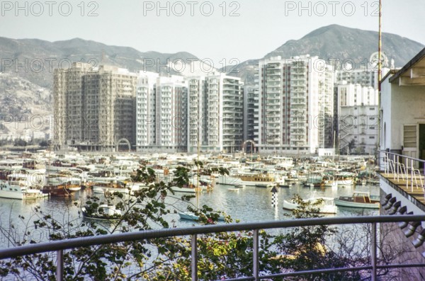High rise apartment buildings and boats including yachts view from Royal Hong Kong Yacht Club, Kellet Island, Causeway Bay, Hong Kong, Asia 1964