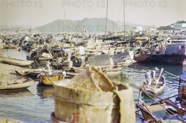 People living on boats, sampans and junks in harbour, Aberdeen, Hong Kong, Asia 1965