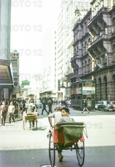 Human rickshaws and green double-decker trolleybus trams, Hong Kong, Asia 1964