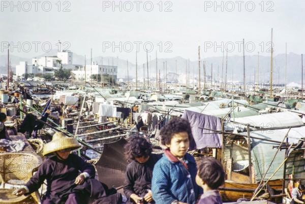 People living on sampan boats near Royal Hong Kong Yacht Club, Kellet Island, Causeway Bay, Hong Kong, Asia 1964