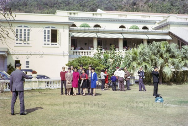 People taking family photos in garden of Repulse Bay Hotel, Repulse Bay, Hong Kong, Asia 1964