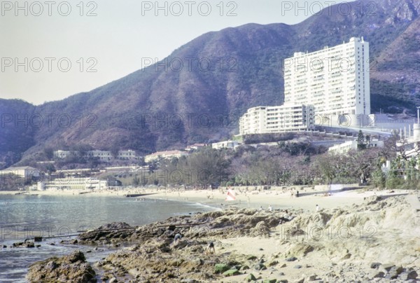 Skyscraper flats from beach in front of Repulse Bay Hotel, Repulse Bay, Hong Kong, Asia 1964
